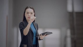 Asian businesswoman interacting with futuristic dashboard showing progress bars and financial metrics. Concept of business performance, KPI, and data analysis. - Powered by Shutterstock - Get 15% off with code: PIKWIZARD15