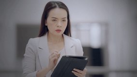 Asian businesswoman using stylus and tablet to analyze business performance via virtual dashboard with charts and globe. Concept of data strategy and global analytics. - Powered by Shutterstock - Get 15% off with code: PIKWIZARD15