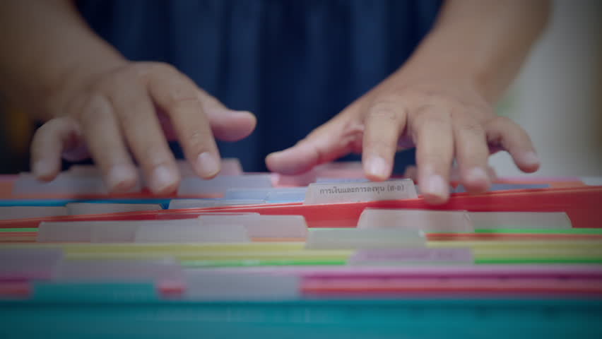 Close-up of hand searching file folder with virtual 3D bar chart overlay showing monthly data. Concept of productivity, document analysis, and digital transformation. - Powered by Shutterstock - Get 15% off with code: PIKWIZARD15
