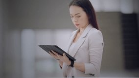 Asian businesswoman using tablet to review a virtual dashboard with global map, charts, and monthly data. Concept of business analytics, data strategy, and digital performance. - Powered by Shutterstock - Get 15% off with code: PIKWIZARD15