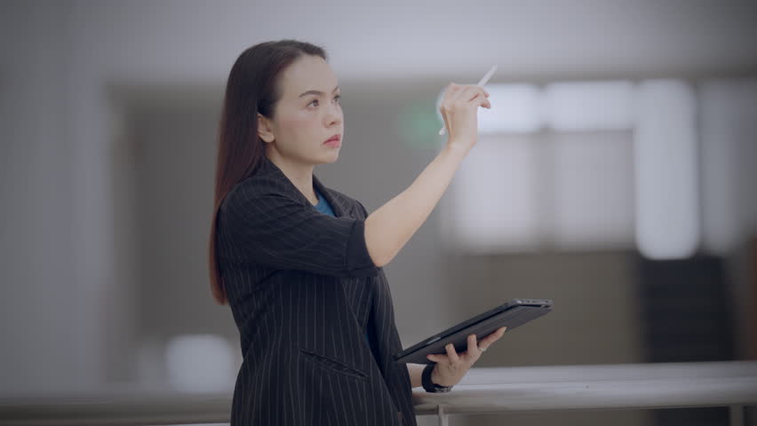 Asian businesswoman analyzing digital data on futuristic virtual screen in modern office. Concept of smart technology, digital analytics, and innovation in business strategy. - Powered by Shutterstock - Get 15% off with code: PIKWIZARD15