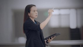 Asian businesswoman analyzing digital data on futuristic virtual screen in modern office. Concept of smart technology, digital analytics, and innovation in business strategy. - Powered by Shutterstock - Get 15% off with code: PIKWIZARD15