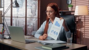 Caucasian happy business woman presenting document with chart diagram talking video call conference using laptop in office businesswoman female girl analytics communicate strategy data growth showing - Powered by Shutterstock - Get 15% off with code: PIKWIZARD15