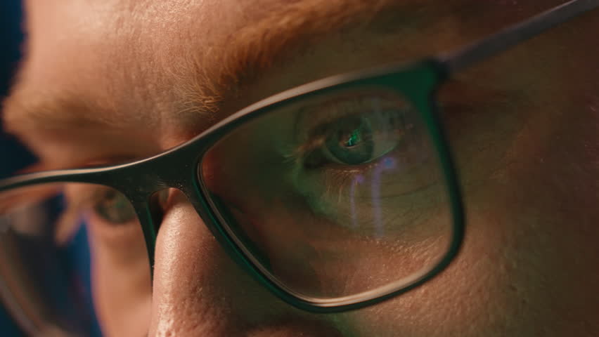 Close up business male eyes in eyeglasses looking in computer vision eyesight medicine health care concentrated man businessman wearing glasses guy at evening night gamer programmer reflected screen