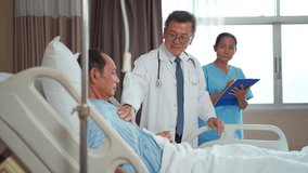 Asian doctor and medical nurse assistant visiting elderly male patient in hospital recovery room. Doctor discussing health condition while nurse records notes on tablet. Concept of healthcare, treatme - Powered by Shutterstock - Get 15% off with code: PIKWIZARD15