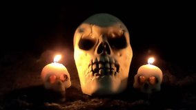 Large skull and two small skull candles with glowing eyes. - Powered by Shutterstock - Get 15% off with code: PIKWIZARD15