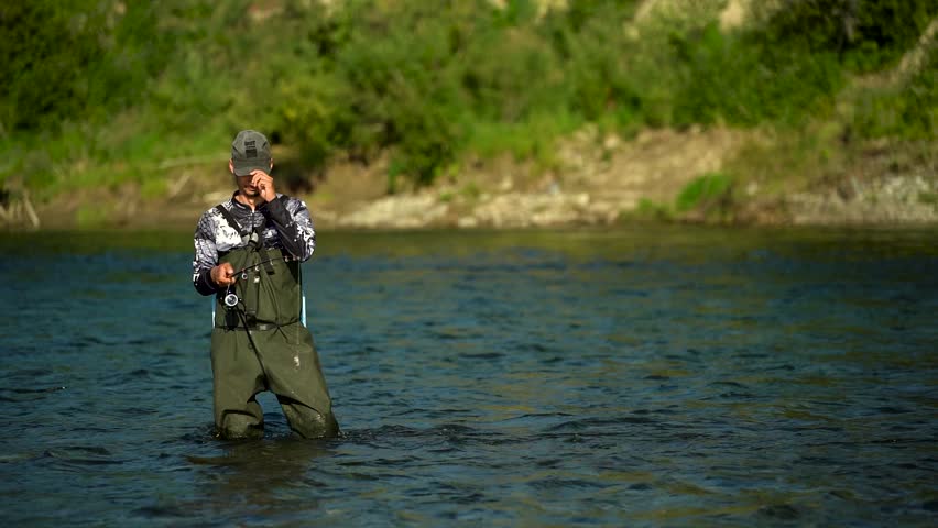 A fisherman casts his spinning rod while fishing