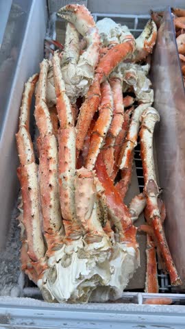 Frozen king crab legs displayed in freezer at seafood market video