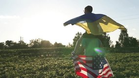 Father and son hold American and Ukrainian flags. Symbol of US support for Ukraine during the war. - Powered by Shutterstock - Get 15% off with code: PIKWIZARD15