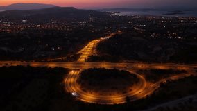 Light trails from flowing traffic on a highway at night with a glowing city view. This aerial drone footage symbolizes modern urban life and transportation networks. - Powered by Shutterstock - Get 15% off with code: PIKWIZARD15