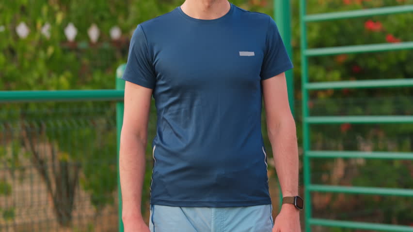 Close up shot of a man rubbing his elbow after a workout. Outdoor summer exercise