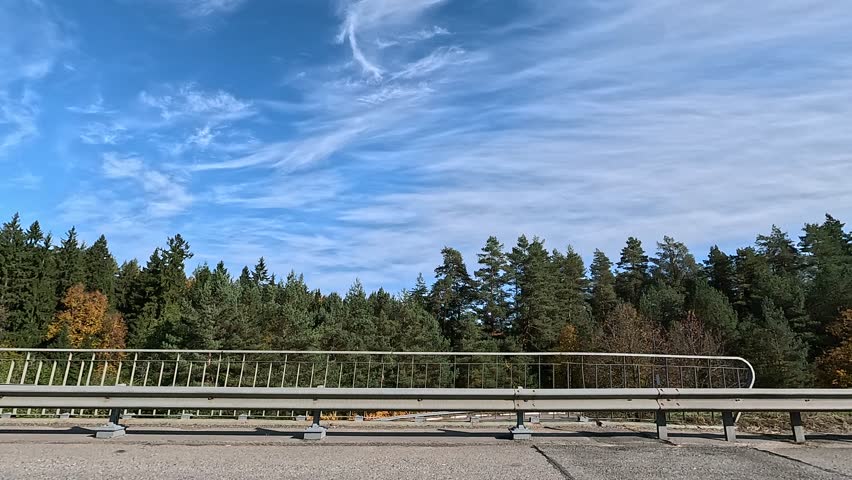 Roadside and road on a sunny day. Along the road, roadside view. Autumn and summer day.