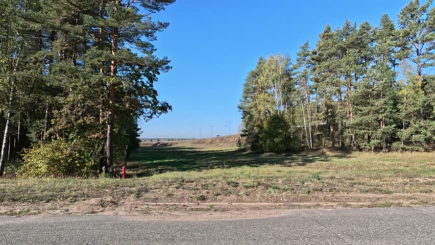 Roadside and road on a sunny day. Along the road, roadside view. Autumn and summer day.