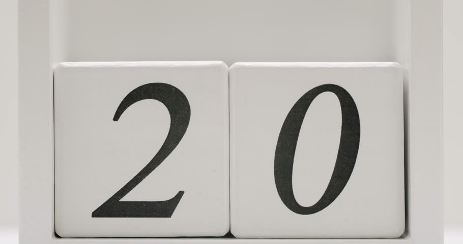 Close-up view of white wooden calendar blocks displaying the number 20, representing a date or countdown. Close-up of Wooden Calendar Blocks Displaying Number 20