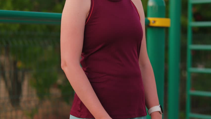 Close up shot of a woman massaging her elbow after a workout. Outdoor summer exercise