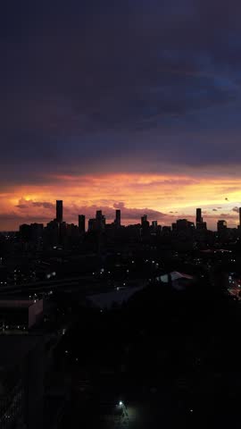 Aerial drone view of Brisbane city skyline at sunset with colorful sky, modern skyscrapers and urban landscape in Queensland, Australia