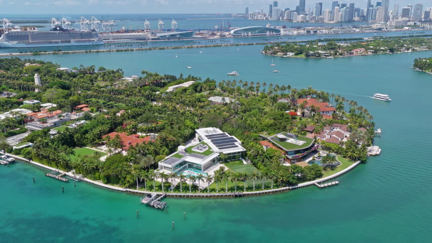 Residential buildings in luxury Star island surrounded by sea. Waterfront residential area on Star island, Miami. Florida landscape view. Star Island in Miami beach, Florida. Luxury Mansions