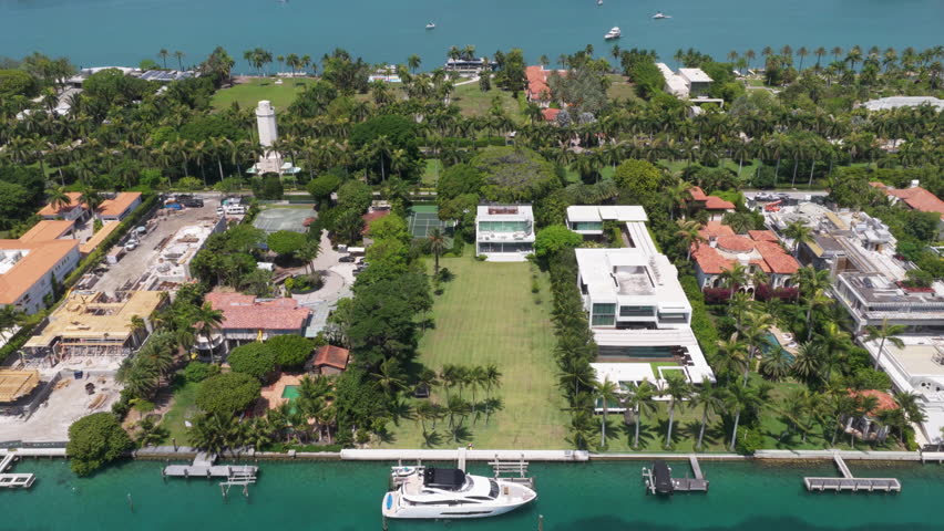 Residential buildings in luxury Star island surrounded by sea. Waterfront residential area on Star island, Miami. Florida landscape view. Star Island in Miami beach, Florida. Exclusive community