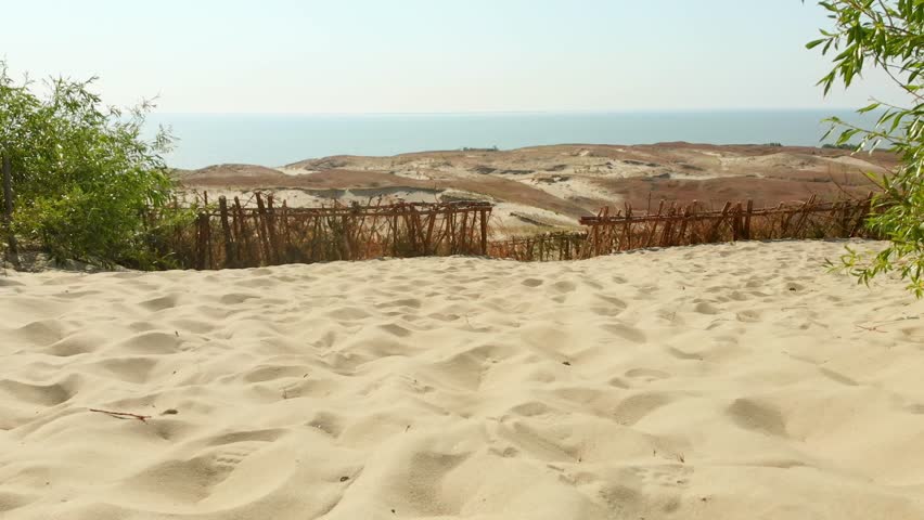 Close up tourist point of view walk on golden sand beach dunes on vacation outdoors in summer. Curonian spit national park. Travel in Lithuania.Wellness and well-being concept