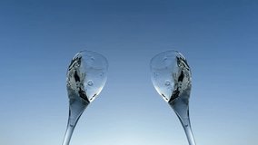 Champagne splashes from champagne glass on sunset blue sky. Romantic glass of white wine with bubbles, splashes. Champagne spilling from glass. Sparkling wine bubbles splash. Vibrant liquid splashing. - Powered by Shutterstock - Get 15% off with code: PIKWIZARD15