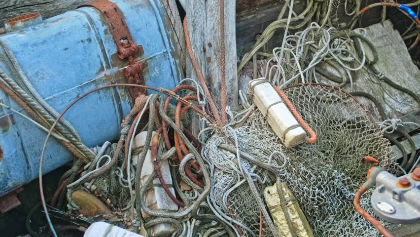 Abandoned Fishing Vessel Deck Mess with Industrial Fishery Equipment with Nylon Net and Styrofoam Fishing Float and Nautical Linen Ropes