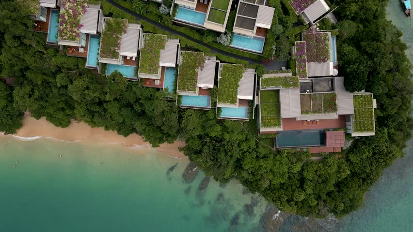 Aerial view of large resort houses villas with swimming pool in upscale residential neighborhood in Thailand, Phuket, near Krabi. Luxury villa with swimming pool, directly above ascending view.