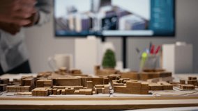 Close up of diverse developers focuses on 3D models layout presentations with detailed city planning for a residential area, waiting for project approval. Infrastructure growth master plan. Camera A. - Powered by Shutterstock - Get 15% off with code: PIKWIZARD15