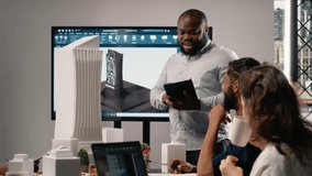 Urban development diverse team discussing property investment new strategy for project approval in a bright office setting, analyzing blueprints and 3D models on architectural software. Camera B. - Powered by Shutterstock - Get 15% off with code: PIKWIZARD15