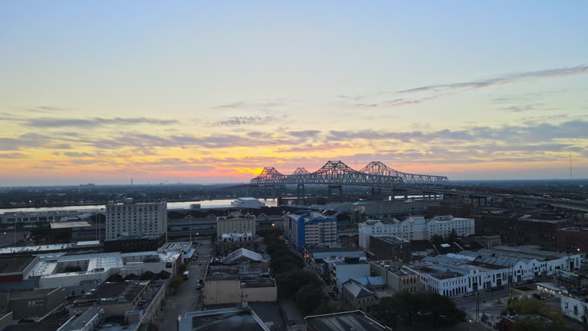 Sunrise drone video of bridge in downtown New Orleans over Mississippi River