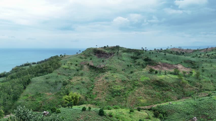 Beautiful tropical coastal landscape with turquoise sea and forested hills, ideal for travel, eco tourism, and summer holiday backgrounds.