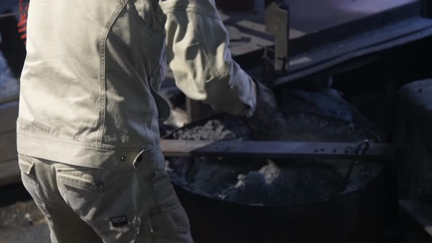 A craftsman removes a knife after annealing