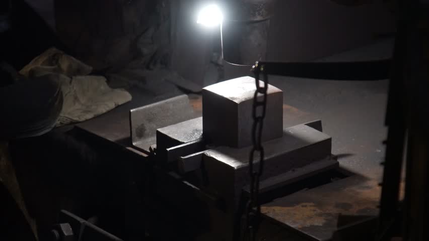 A craftsman stamping a knife