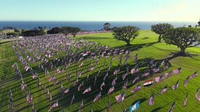 Aerial footage showcases vibrant mostly American flags waving in the coastal breeze at a picturesque park in Malibu, California, USA, reflecting deep patriotism and memorial of September 11 2001 - Powered by Shutterstock - Get 15% off with code: PIKWIZARD15