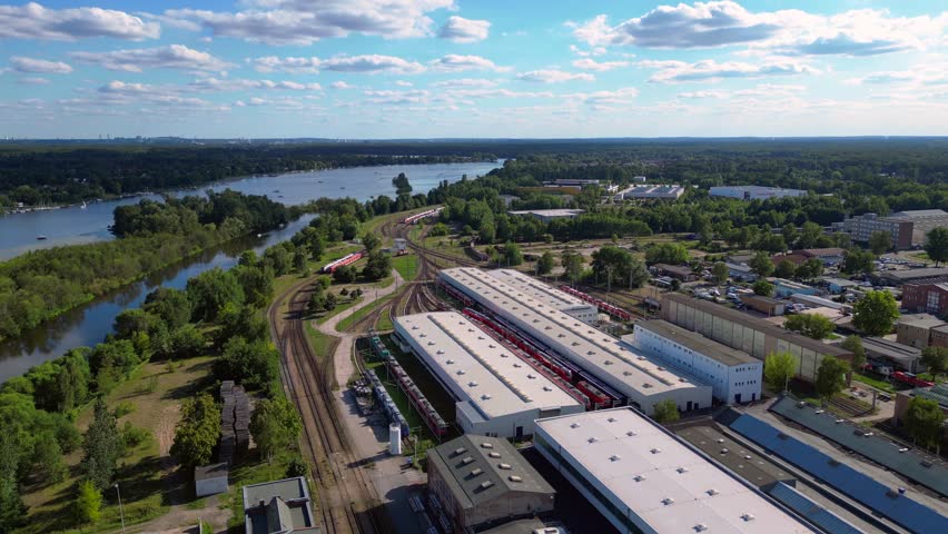 Hennigsdorf railway factory train depot overlooking the river in Brandenburg, Germany. Marvelous aerial view flight panorama orbit drone
