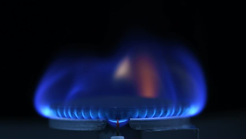Blue gas flame on a kitchen cooktop