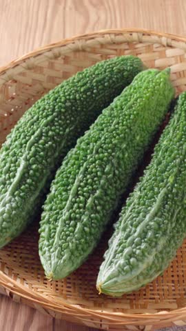Fresh Bitter Melon (Goya) on Bamboo Colander