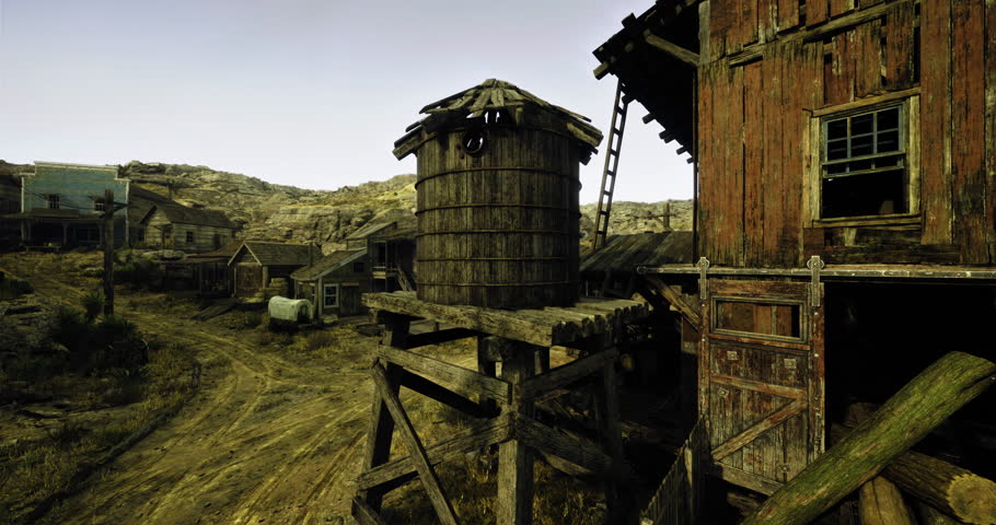 A desolate western town features weathered wooden buildings and a large water tower. Dusty paths wind through the settlement, reflecting an atmosphere of the old frontier.