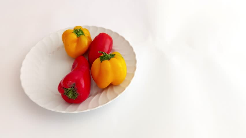 Colorful bell peppers-red, yellow, orange-neatly arranged on a bright backdrop. Crisp textures and natural hues evoke freshness, simplicity, and garden-to-table vibes