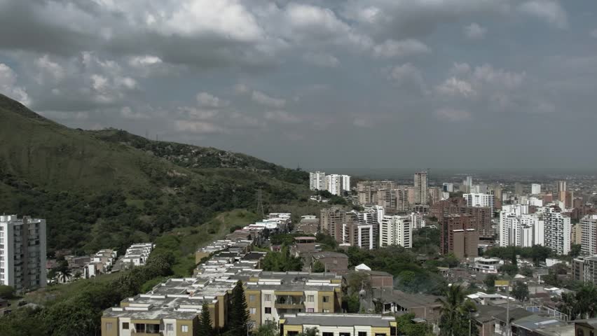 Aerial drone photo of western Cali Colombia showing urban cityscape with mountains and natural landscape.