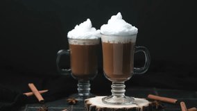 Two warm drinks topped with cream and cinnamon sticks with star anise on a dark background - Powered by Shutterstock - Get 15% off with code: PIKWIZARD15