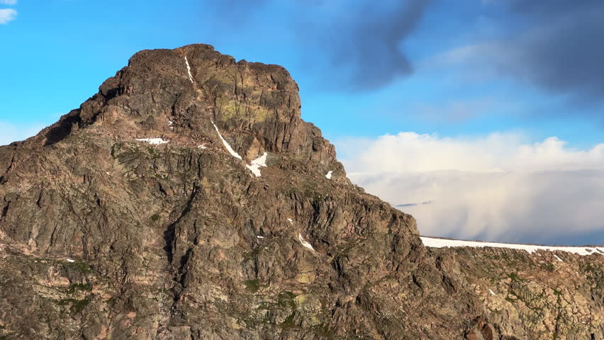 Close up Mount of the Holy Cross 14er peak north ridge half-moon pass trail spring summer Rocky Mountains Colorado blue sky clouds landscape nature view of 14er summit snow field cornice static