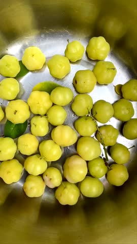 Fresh Phyllanthus acidus or cermai fruit on bowl. Phyllanthus acidus is a fruit that tastes sour and lots of vitamins