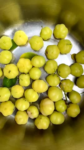 Fresh Phyllanthus acidus or cermai fruit on bowl. Phyllanthus acidus is a fruit that tastes sour and lots of vitamins