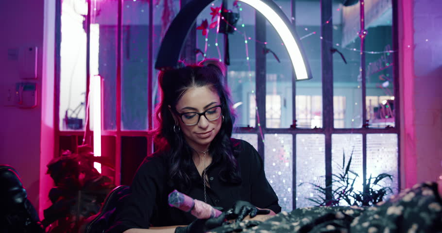 Woman, tattoo artist and face at parlor with smile, pride and confident for craft, design or culture. Person, entrepreneur or small business owner for body art for client, creativity or job at studio