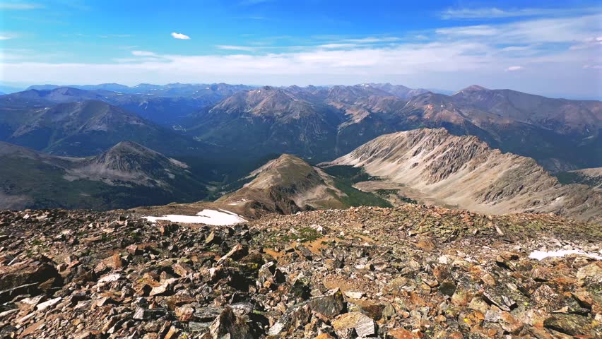 La Plata Peak Gulch Trail 14er view of Independence Pass Sawatch Range 14er spring summer Rocky Mountains Colorado high alpine elevation above treeline snow fields morning blue sky haze pan left