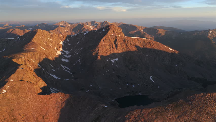 First light golden sunrise early morning aerial drone view Mount of the Holy Cross 14er peak Wilderness Halo Ridge Trail Notch mountain Bowl of Tears lake Sawatch Range Rocky Mountains Colorado circle