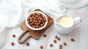 Two hot chocolate drinks topped with whipped cream beside a small pumpkin and cinnamon sticks. - Powered by Shutterstock - Get 15% off with code: PIKWIZARD15