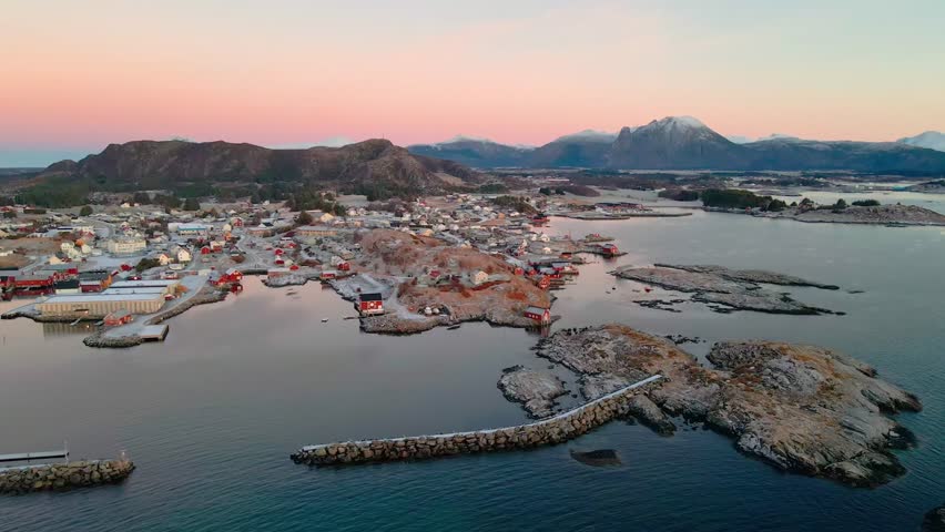 Drone footage capturing the picturesque Henningsv a charming fishing village nestled in the stunning Lofoten Islands of Norway, featuring traditional rorbuer, harbor,