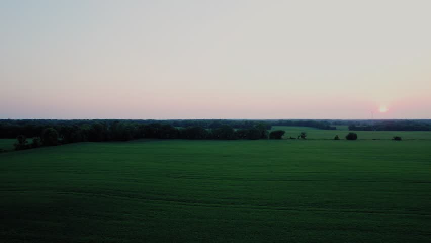 Vast green farmland and forests at sunset, capturing the peaceful rural landscape of Milton, Wisconsin.