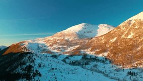 aerial footage showcasing the majestic snow covered mountains near Elnesvagen, Norway, bathed in the warm, golden light of alpenglow. - Powered by Shutterstock - Get 15% off with code: PIKWIZARD15